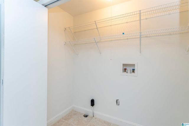 clothes washing area featuring hookup for a washing machine and light tile patterned floors