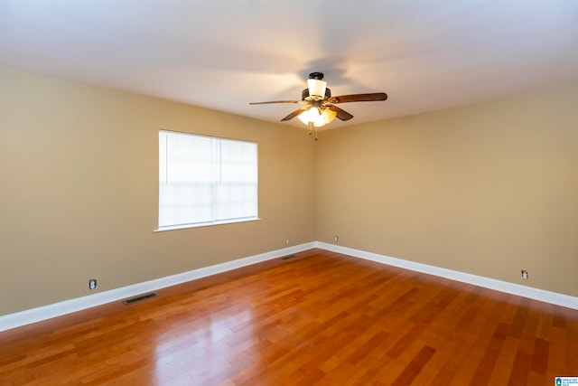 spare room with hardwood / wood-style flooring and ceiling fan