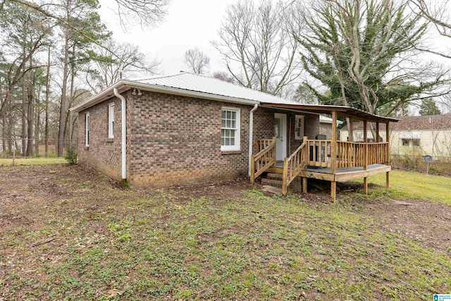 back of property with a wooden deck