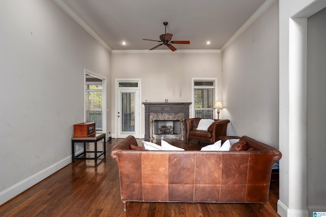 living room featuring ceiling fan, ornamental molding, and dark hardwood / wood-style flooring