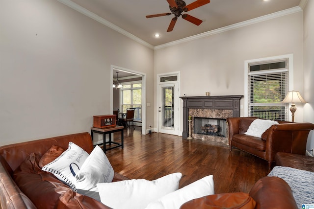 living room with ornamental molding, dark hardwood / wood-style flooring, plenty of natural light, and a high end fireplace