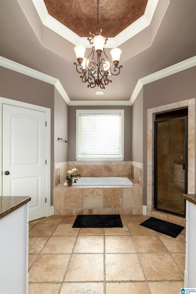 bathroom featuring plus walk in shower, a tray ceiling, vanity, ornamental molding, and an inviting chandelier