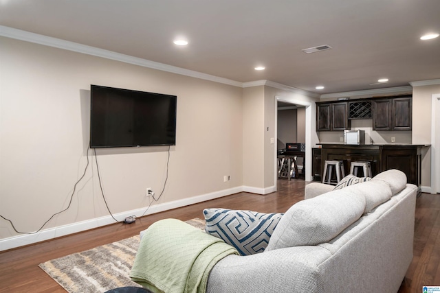 living room with crown molding and dark hardwood / wood-style flooring