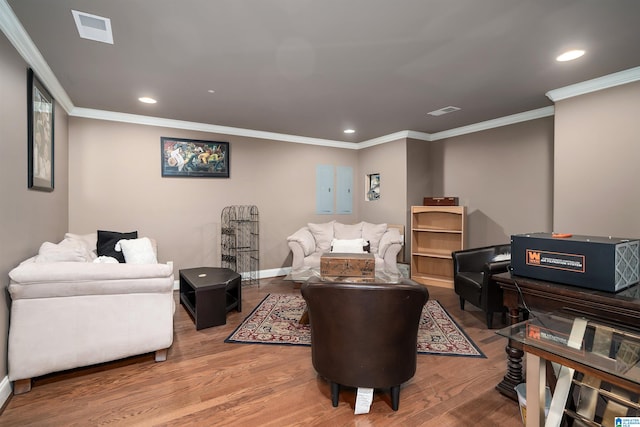 living room featuring crown molding and hardwood / wood-style flooring