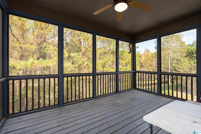 unfurnished sunroom with a wealth of natural light and ceiling fan