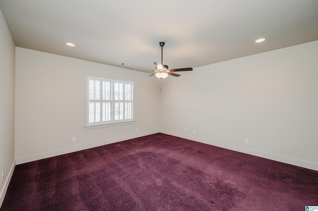 carpeted spare room with ceiling fan