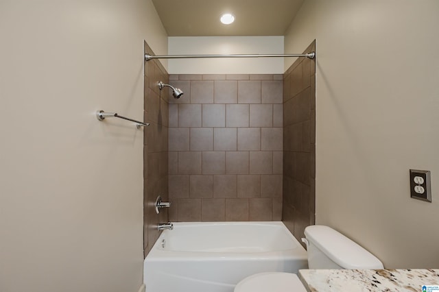 full bathroom with tiled shower / bath, vanity, and toilet