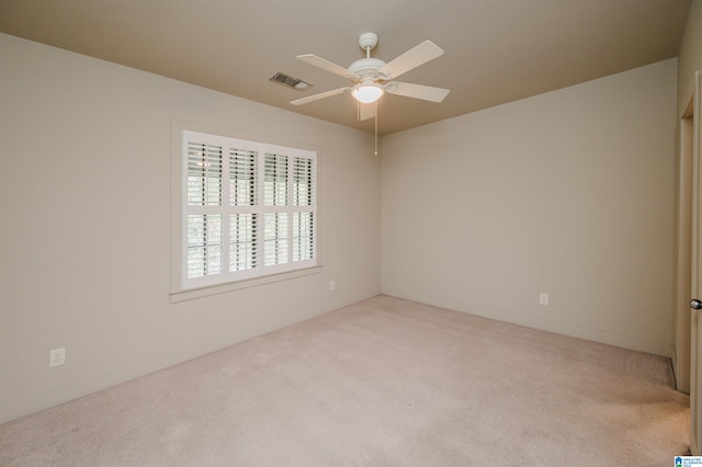 spare room with light colored carpet and ceiling fan