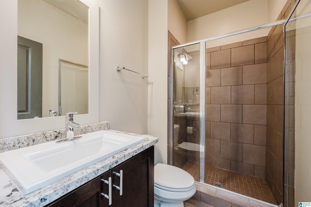 bathroom with vanity, toilet, and walk in shower