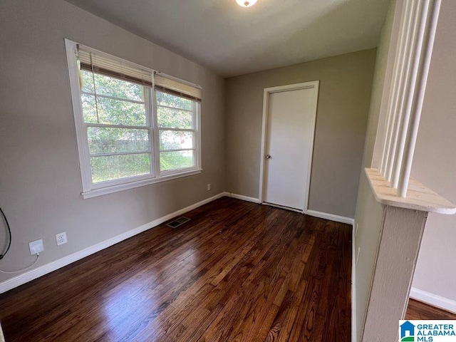 spare room with dark hardwood / wood-style floors