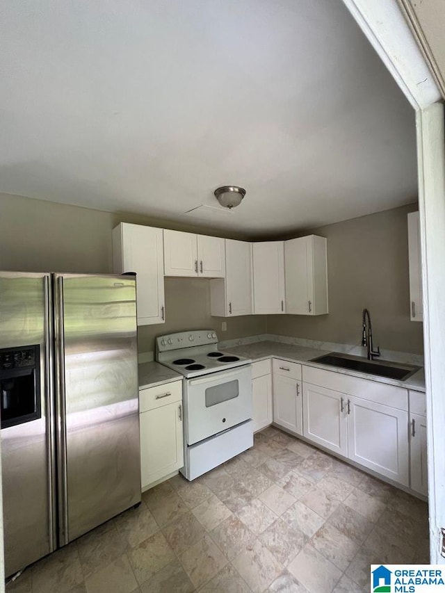 kitchen featuring sink, white cabinets, electric range, and stainless steel refrigerator with ice dispenser