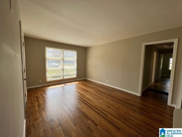 spare room featuring dark hardwood / wood-style flooring