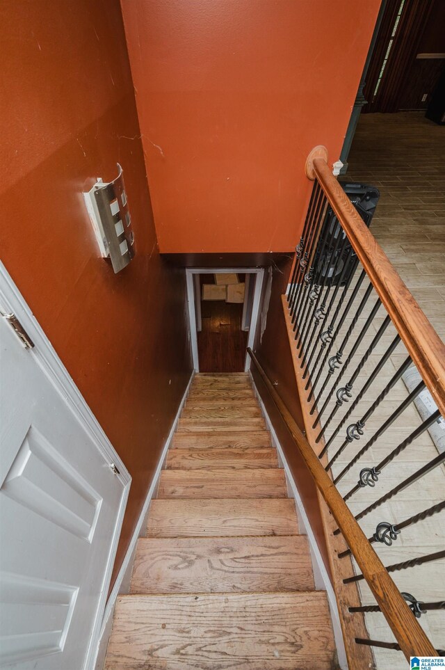 stairs featuring wood finished floors