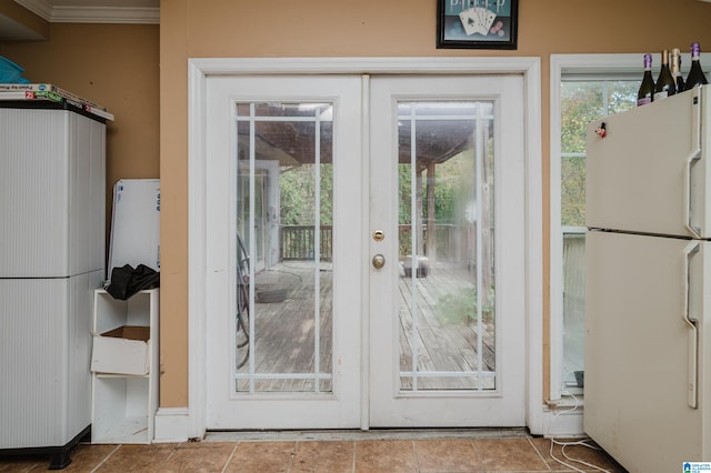 doorway featuring french doors, ornamental molding, and tile patterned floors