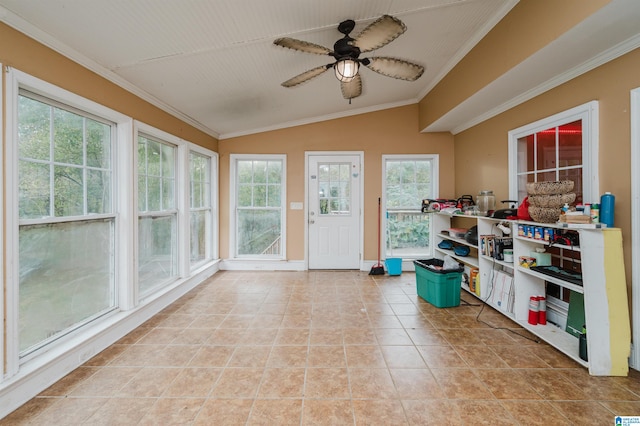 sunroom featuring ceiling fan, vaulted ceiling, and plenty of natural light