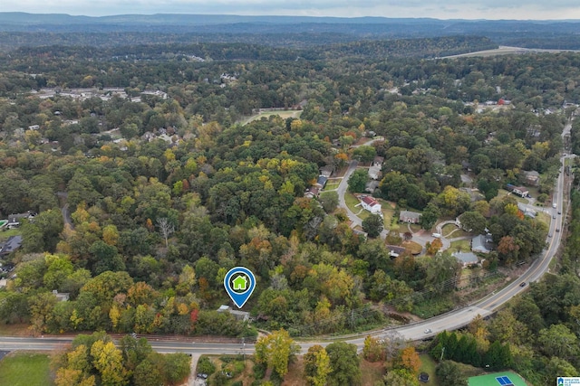 aerial view of property's location with a forest