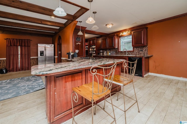 kitchen featuring black appliances, arched walkways, light stone countertops, a breakfast bar area, and light wood-style flooring