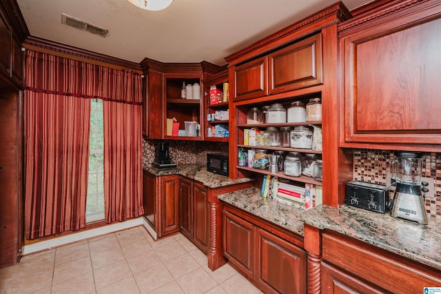 kitchen with tasteful backsplash, black microwave, open shelves, light stone countertops, and light tile patterned flooring