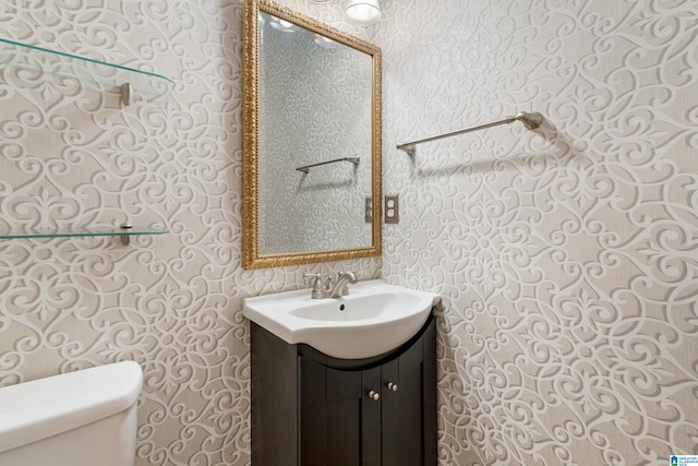 bathroom featuring vanity and toilet