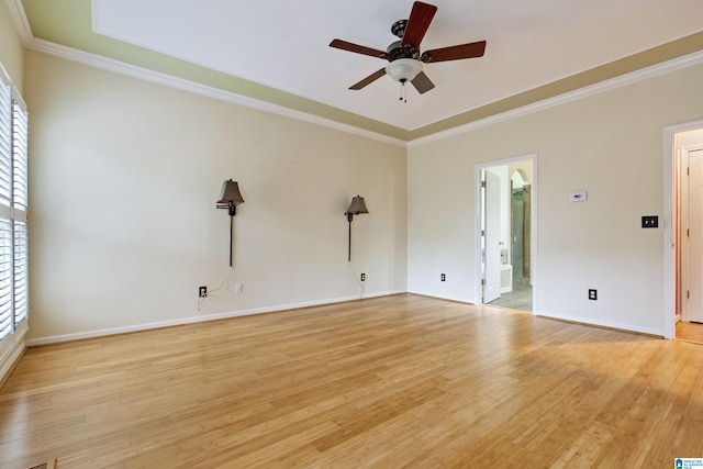 empty room featuring light wood-type flooring, ceiling fan, and crown molding