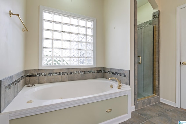 bathroom with separate shower and tub and tile patterned flooring