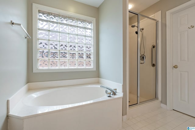 bathroom featuring separate shower and tub, tile patterned flooring, and a healthy amount of sunlight