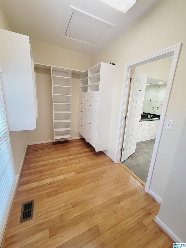 walk in closet featuring light hardwood / wood-style flooring