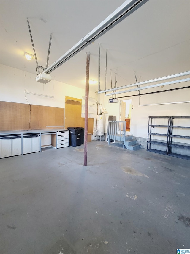 garage featuring a garage door opener and water heater