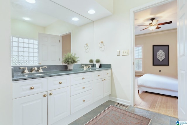 ensuite bathroom with ceiling fan, a sink, double vanity, and ensuite bathroom