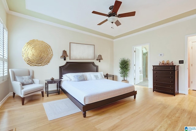 bedroom with light wood finished floors, a ceiling fan, baseboards, and crown molding