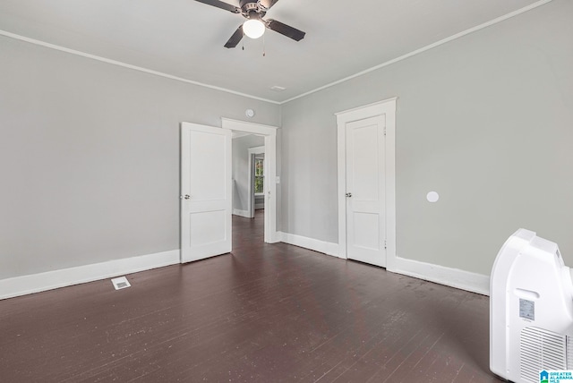 spare room featuring ceiling fan, crown molding, and dark hardwood / wood-style floors