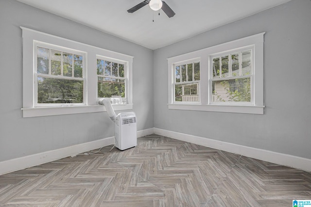 spare room with light parquet flooring and ceiling fan