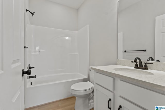 full bathroom with vanity, hardwood / wood-style floors, shower / washtub combination, and toilet