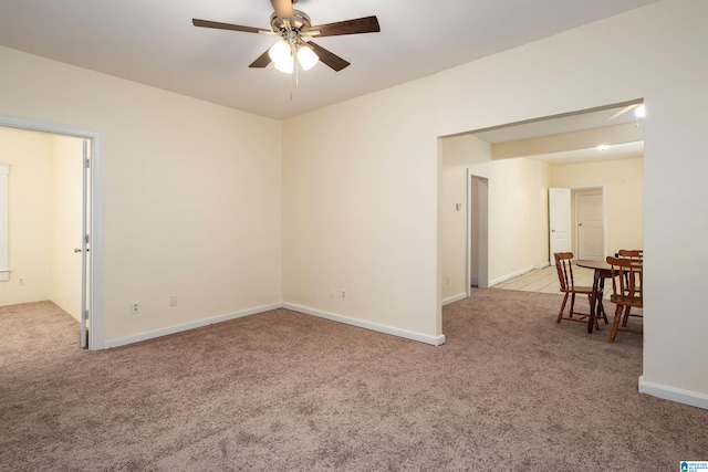 spare room with light colored carpet and ceiling fan