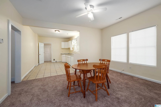 dining room featuring ceiling fan, light carpet, and plenty of natural light