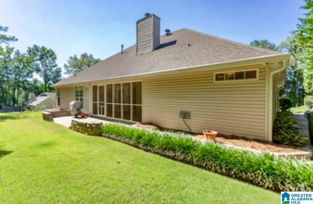 rear view of property with a patio and a yard