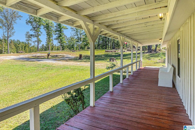 wooden deck featuring a yard