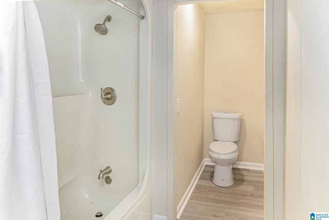 bathroom featuring toilet, shower / tub combo with curtain, and wood-type flooring