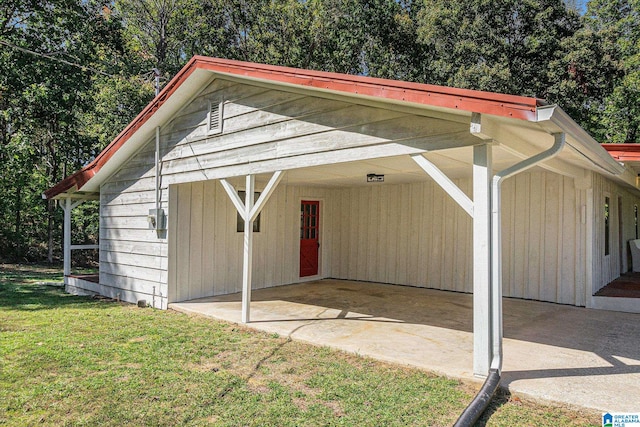 view of outdoor structure featuring a lawn and a carport