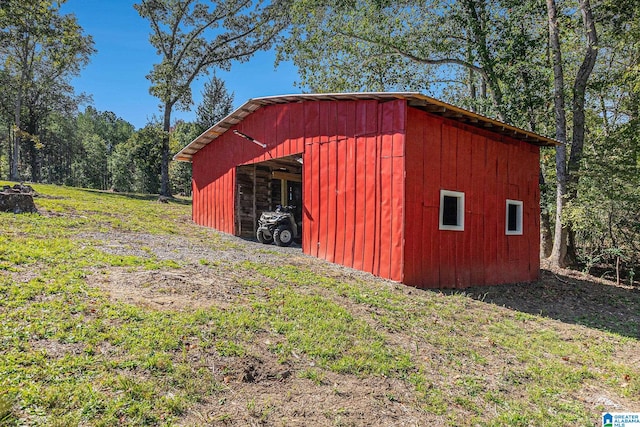 view of outbuilding featuring a yard