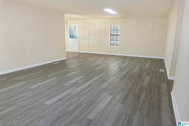 spare room with dark wood-type flooring