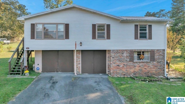 view of front of property with a front yard and a garage