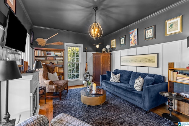 living room featuring ornamental molding, a chandelier, and hardwood / wood-style floors