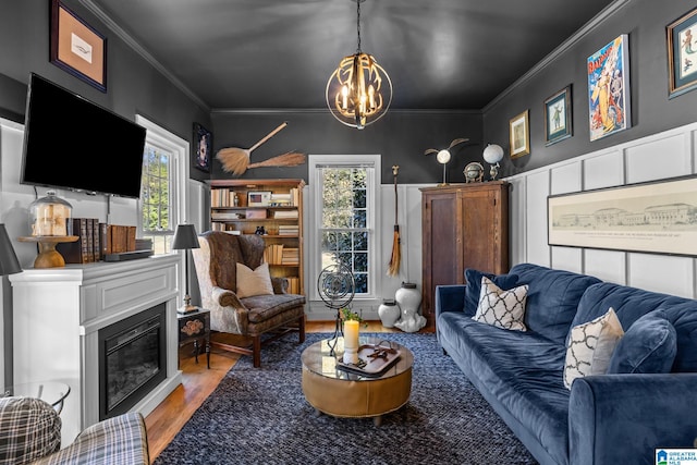 living room featuring ornamental molding, hardwood / wood-style floors, plenty of natural light, and a chandelier