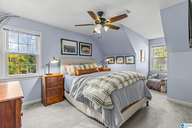 bedroom with vaulted ceiling, light colored carpet, and ceiling fan