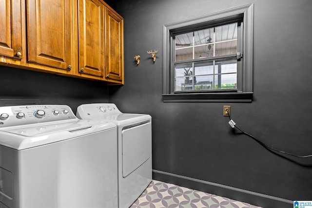 washroom with independent washer and dryer and cabinets