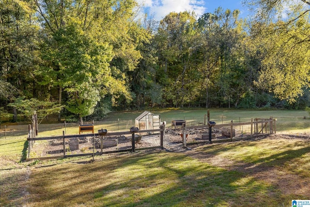 surrounding community featuring a yard and a rural view