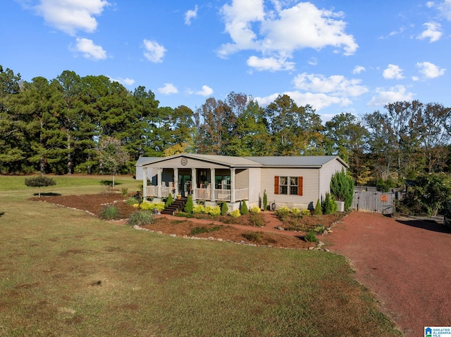 manufactured / mobile home with a front yard and covered porch