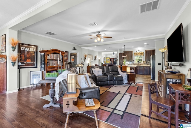 living room featuring ornamental molding, dark wood-type flooring, and ceiling fan