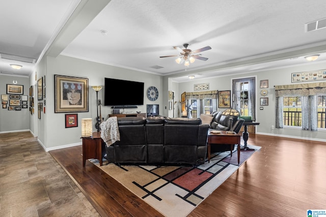 living room with ceiling fan and crown molding